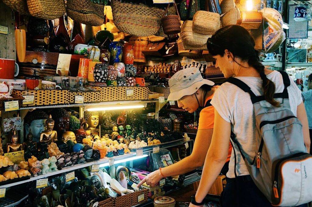 tourists are buying souvenirs in ben thanh market of ho chi minh city