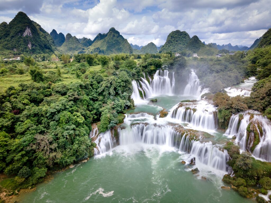 Panoramic view of Ban Gioc Waterfall in Cao Bang, the flowing water looks like white silk ribbons.