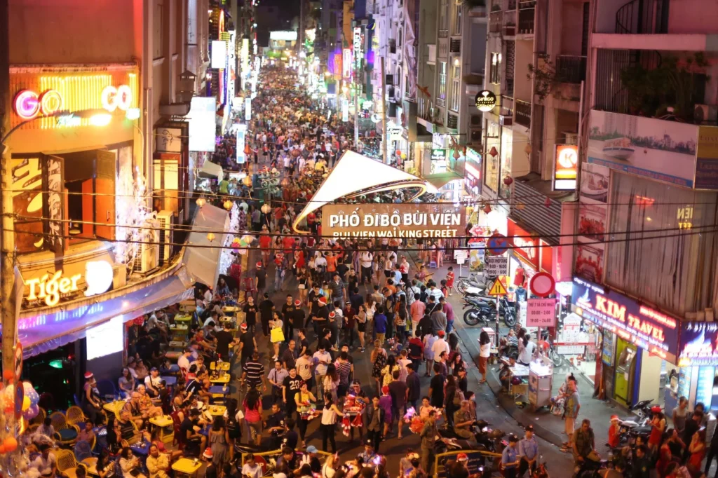 Crowded Bui Vien walking street in Ho Chi Minh City at night.