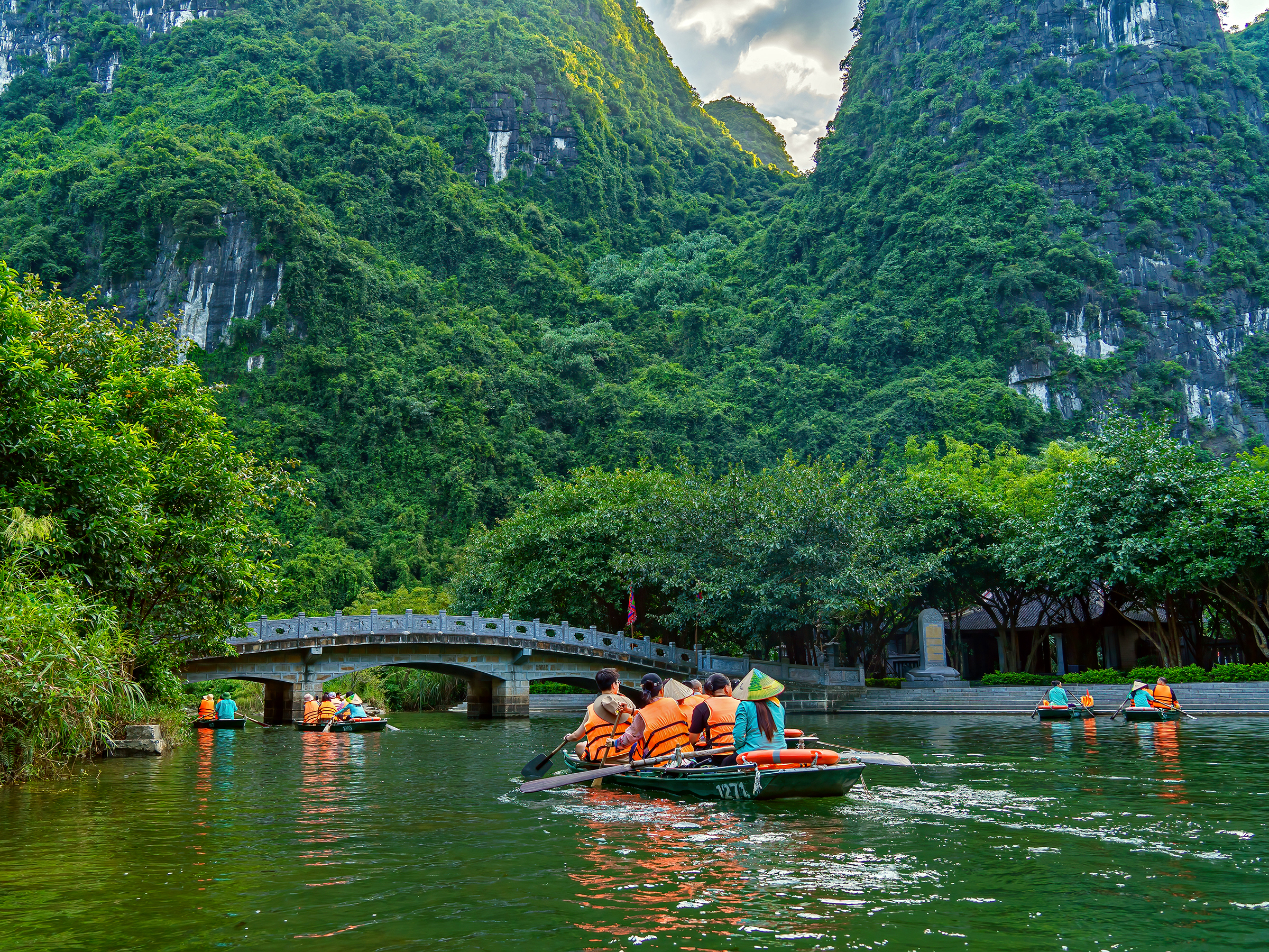 Boat ride through trang an ninh binh, one of the signature experience in a Vietnam Travel Iitnerary