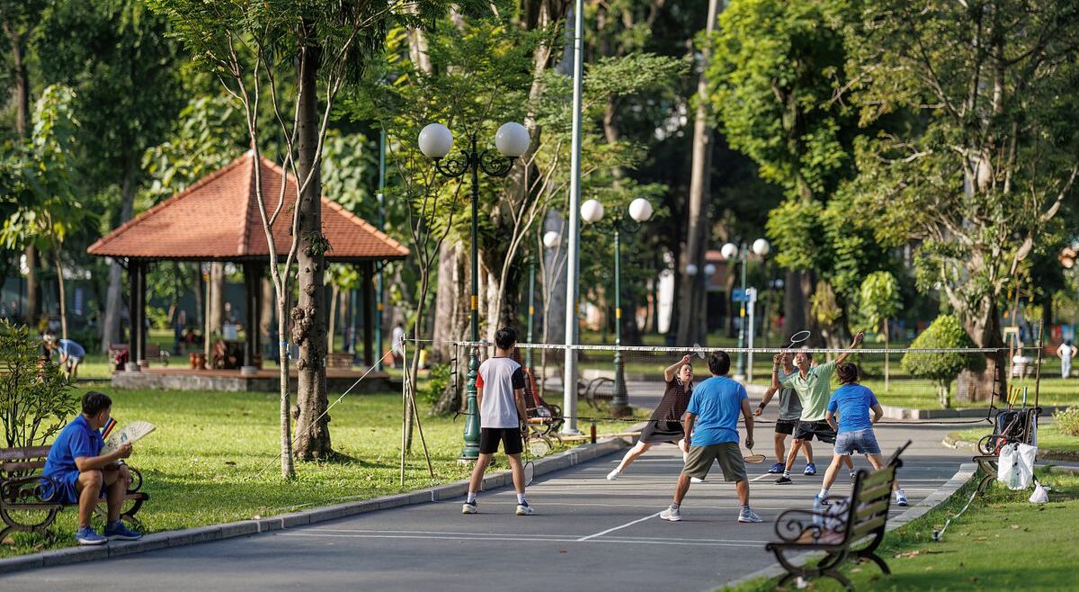 A group of locals playing badminton in Tao Dan Park, enjoying an active morning in Saigon’s green lung in city center.