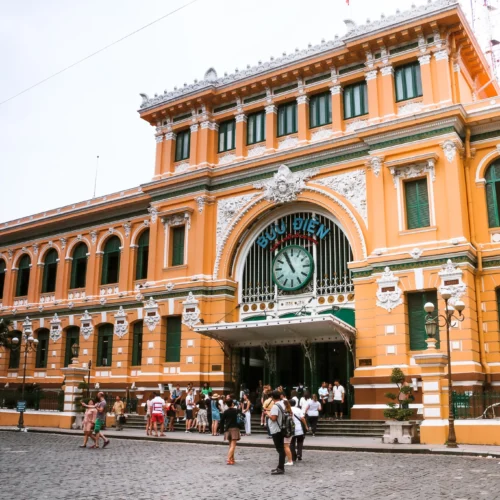 Visitors entering the Saigon Old Post Office, a French colonial landmark featured on the Saigon walking tour.