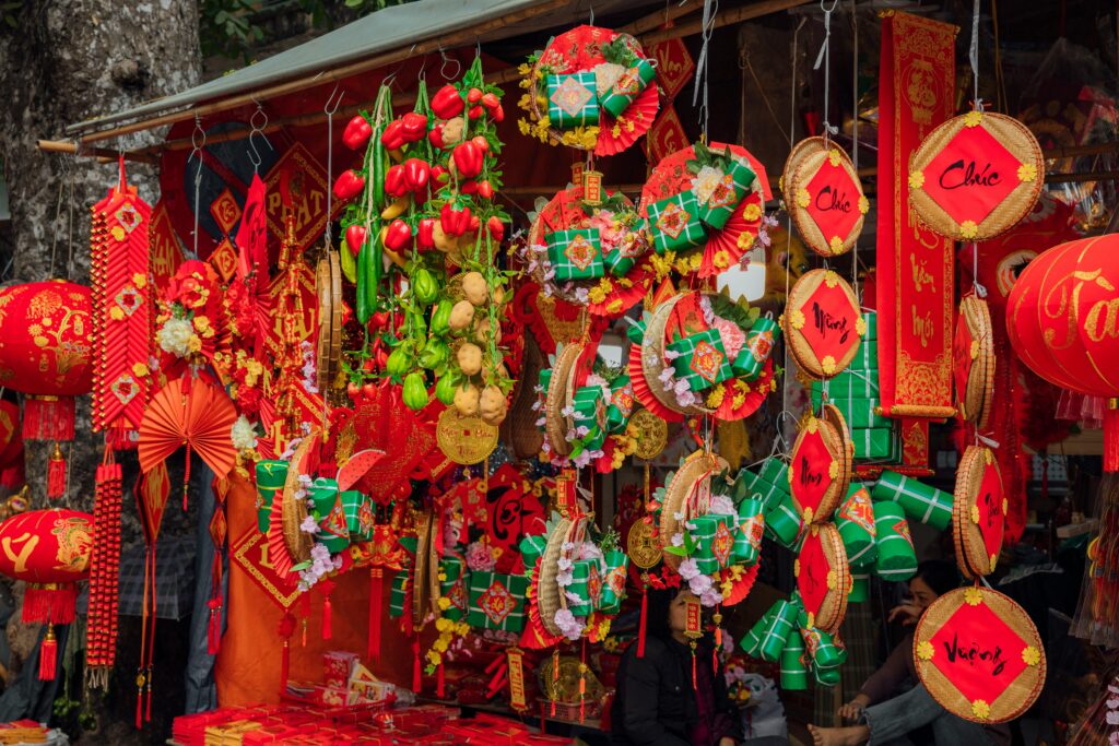 Traditional Vietnamese Tet decorations with red lanterns, calligraphy, and ornaments symbolizing luck and prosperity