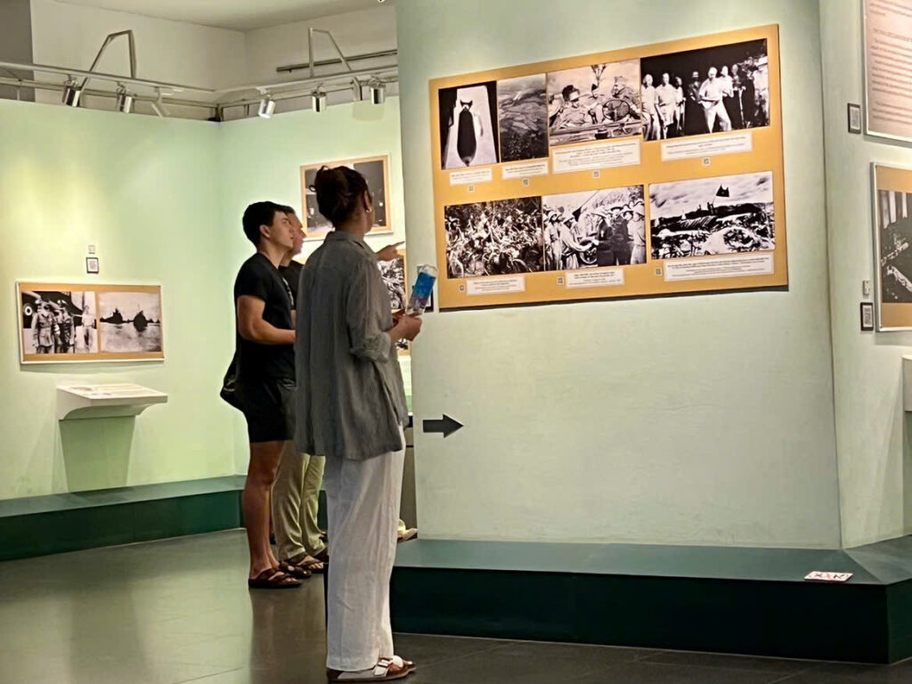 isitor looking at historical photographs inside War Remnants Museum in Ho Chi Minh City.