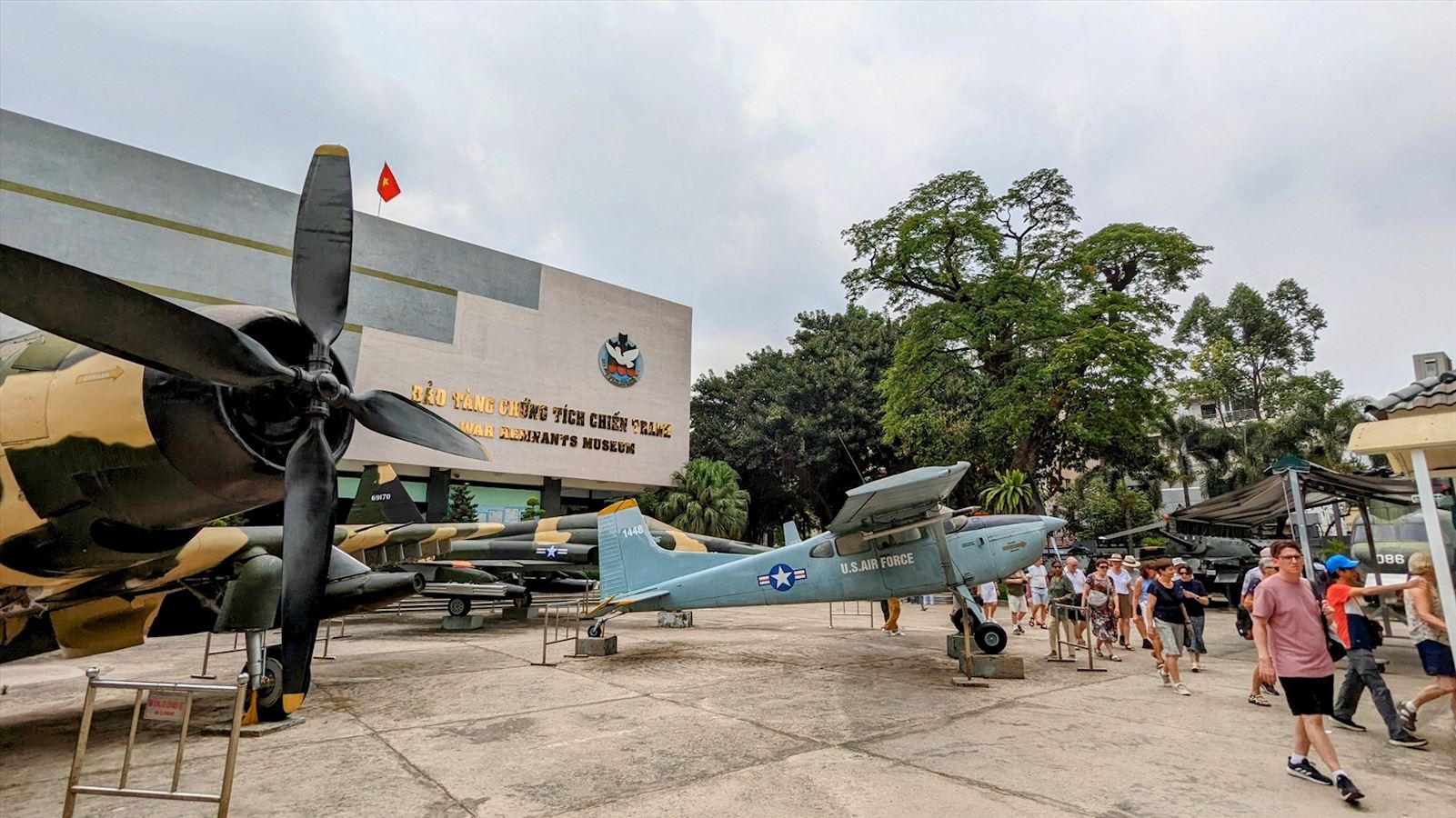 Front view of the War Remnants Museum in Ho Chi Minh City, with two military aircraft displayed outside the entrance. Capturing the historical of vietnam