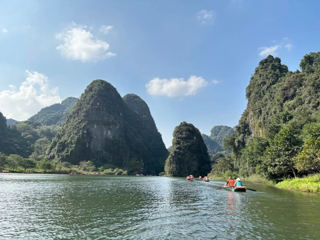 rowing boat through ninh binh's limestone landscape in trang an