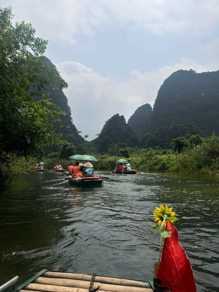rowing boat through ninh binh's limestone landscape in trang an