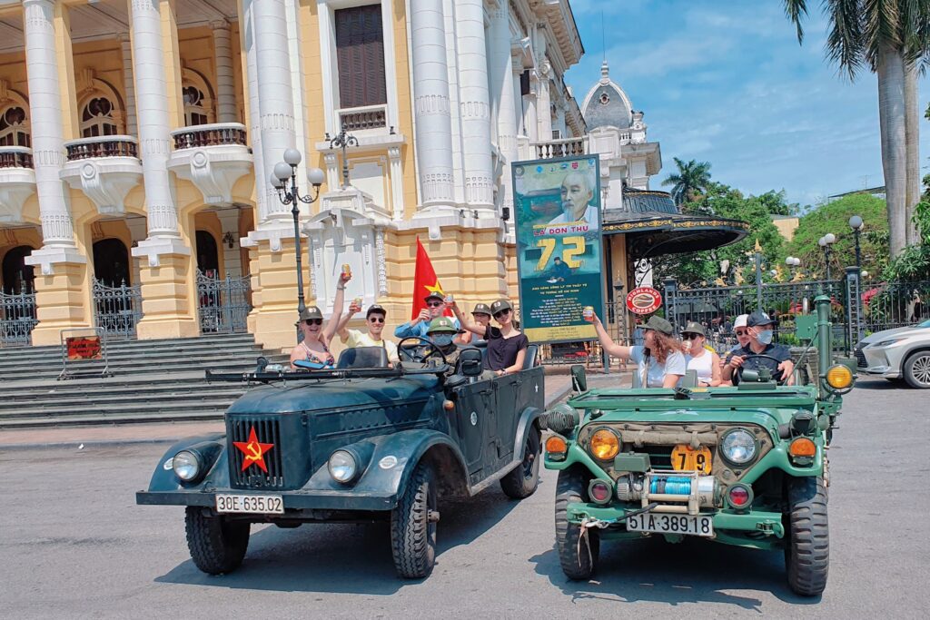2 groups of travelers in a hanoi vintage jeep tour to explore the city