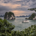 halong bay large view with a cruise in sunset
